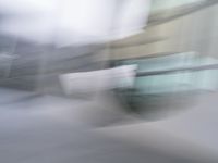 a blurry image of a man riding a skateboard on the road using motion blurred