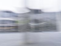 a blurry image of a man riding a skateboard on the road using motion blurred