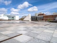 a stone slab with an empty building in the background and a white wall behind it