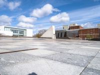 a stone slab with an empty building in the background and a white wall behind it