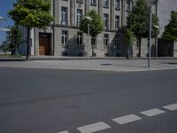 a person is standing in the middle of the street in front of the building and has two skateboards
