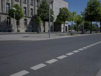 a person is standing in the middle of the street in front of the building and has two skateboards