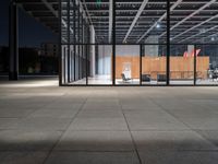 a chair inside of a building with glass walls on top of it and lots of wood