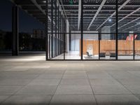 a chair inside of a building with glass walls on top of it and lots of wood