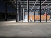 a chair inside of a building with glass walls on top of it and lots of wood