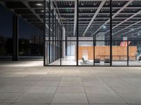 a chair inside of a building with glass walls on top of it and lots of wood