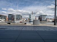 a very big building with a lot of boats near it by the water and some buildings