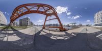 an upside down view of a bridge over a body of water from a fisheye lens