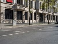 a building with windows and signs on the side of it on a city street in europe