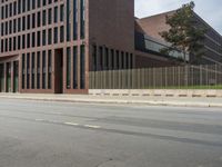 there is a large building on the other side of the street in this shot from the left of the road