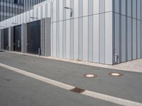 there is a brick walkway outside a building on this street with white fence and concrete curbes