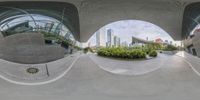 an image taken in the reflection of a fish - eye view of a building and plants