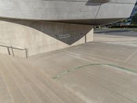 a picture of a staircase leading up to a building on a city street in front of parking lot