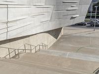 a picture of a staircase leading up to a building on a city street in front of parking lot