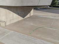 a picture of a staircase leading up to a building on a city street in front of parking lot