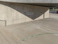 a picture of a staircase leading up to a building on a city street in front of parking lot