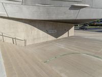 a picture of a staircase leading up to a building on a city street in front of parking lot