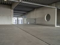 a empty room with metal roof in a large building with sliding glass doors and a flat roof