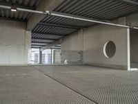 a empty room with metal roof in a large building with sliding glass doors and a flat roof