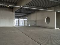 a empty room with metal roof in a large building with sliding glass doors and a flat roof