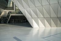 the view of a modern building with a stone staircase and glass walls in front of it