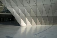 the view of a modern building with a stone staircase and glass walls in front of it