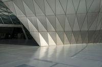 the view of a modern building with a stone staircase and glass walls in front of it