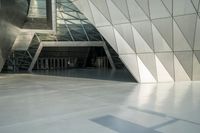 the view of a modern building with a stone staircase and glass walls in front of it