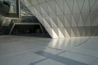 the view of a modern building with a stone staircase and glass walls in front of it