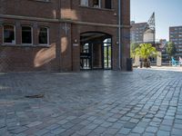 the building has a large metal door leading to it's entrance and on a brick road