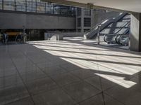 a lobby area inside the building with stairs and steps in the background on a clear day