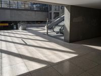 a lobby area inside the building with stairs and steps in the background on a clear day