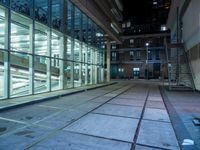 large windows inside a very modern building at night in the city of london, england