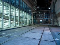 large windows inside a very modern building at night in the city of london, england