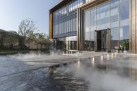 the entrance of a building is reflecting the water on the floor and walls, making smoke rising from the windows