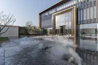 the entrance of a building is reflecting the water on the floor and walls, making smoke rising from the windows