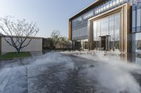 the entrance of a building is reflecting the water on the floor and walls, making smoke rising from the windows