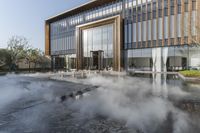 the entrance of a building is reflecting the water on the floor and walls, making smoke rising from the windows