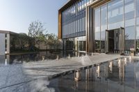 the entrance of a building is reflecting the water on the floor and walls, making smoke rising from the windows