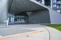 a building with two large windows on the side of it, and a walkway below with a fire hydrant outside