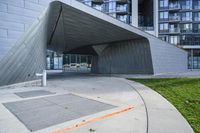 a building with two large windows on the side of it, and a walkway below with a fire hydrant outside