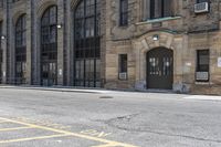 the building has arched windows that are lit by streetlights on both sides of the building