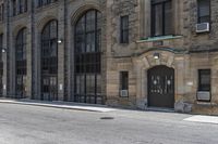 the building has arched windows that are lit by streetlights on both sides of the building