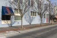 a building is located on the side of the street in the sun and there's no one walking near it