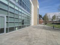 there is a building with many windows on it and grass around the building is also empty