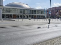 an empty city street that is in the daytime time with several signs on it's sides