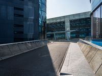 a skateboarder performing a trick on the side of a road in front of a building