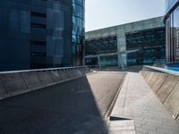 a skateboarder performing a trick on the side of a road in front of a building