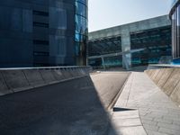 a skateboarder performing a trick on the side of a road in front of a building