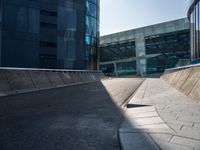 a skateboarder performing a trick on the side of a road in front of a building